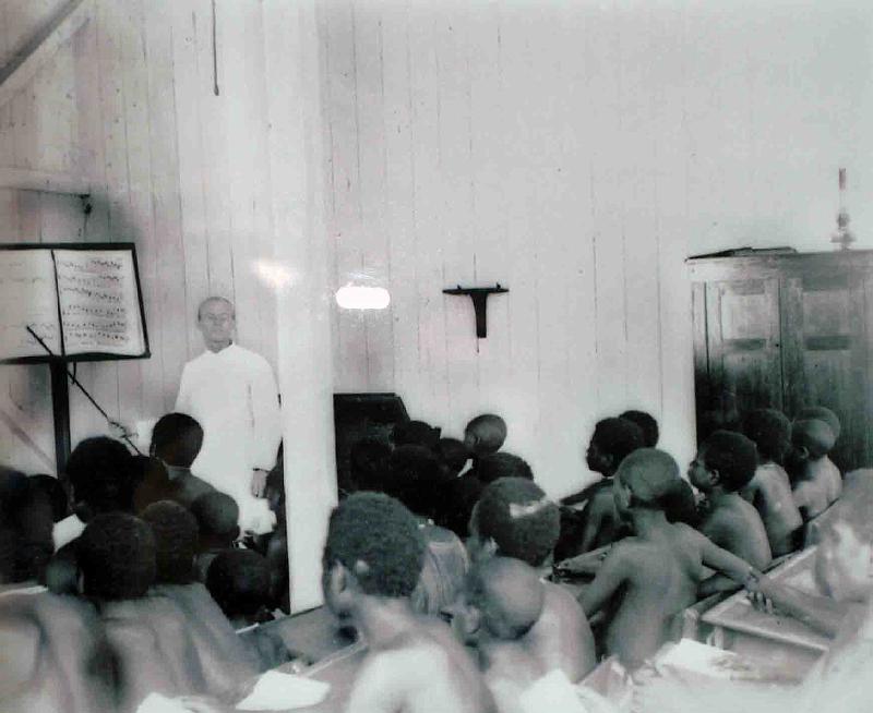 PNG7-17.jpg - Singers learning to sight-read, Central Catholic school, Tumleo. The teacher is Brother Clarentius (August Petry), SVD 1906 (source photo: exhibition “Tupela Poroman”, East New Britain Historical and Cultural Centre, Kokopo)(Photo by Roland Seib)