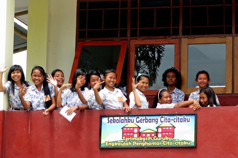 Papua1-07-Zoellner.jpg - School children of  a secondary school in Abepura. The poster reads: “My school is the gate to my wishes, thank you, my teacher” . All girls are non-Papuas, children of migrants (2011)(Photo by Siegfried Zöllner)