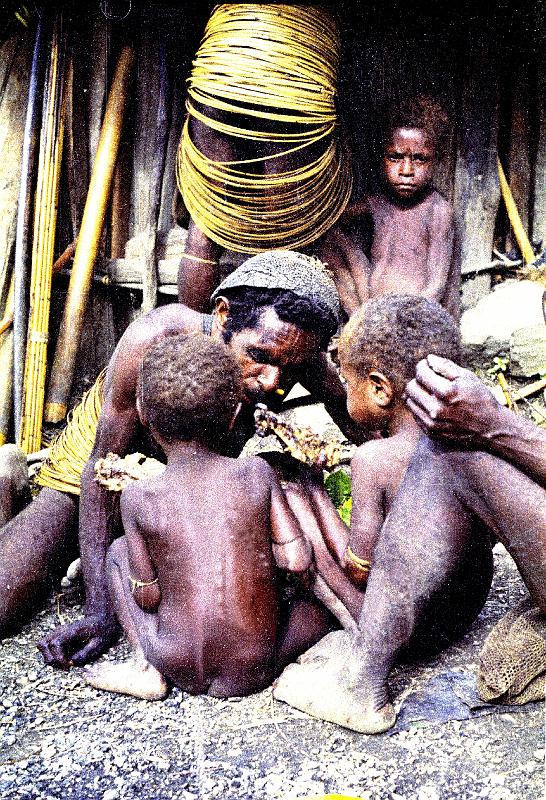 Papua1-23-Zoellner.JPG - Yali medicine man (hal ahun) treating two boys as part of the initiation ceremony, Angguruk, Yahukimo regency, Highlands (1967)(Photo by Siegfried Zöllner)