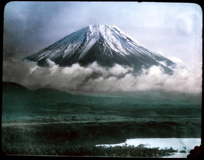 Fuji-05b-Geddes-1910.jpg - A view of Mount Fuji. Item is a photographic glass-plate transparency; part of a set of colour-tinted transparencies depicting life in Japan ca. 1910, including scenery, street scenes, workers, farming, fishing, silk production, stone carvers, wood carvers, metal workers, potters, and artists. Photo by Herbert Geddes/University of Victoria Libraries